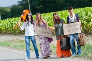 15121330-hippie-group-hitchhiking-on-a-countryside-road-italy
